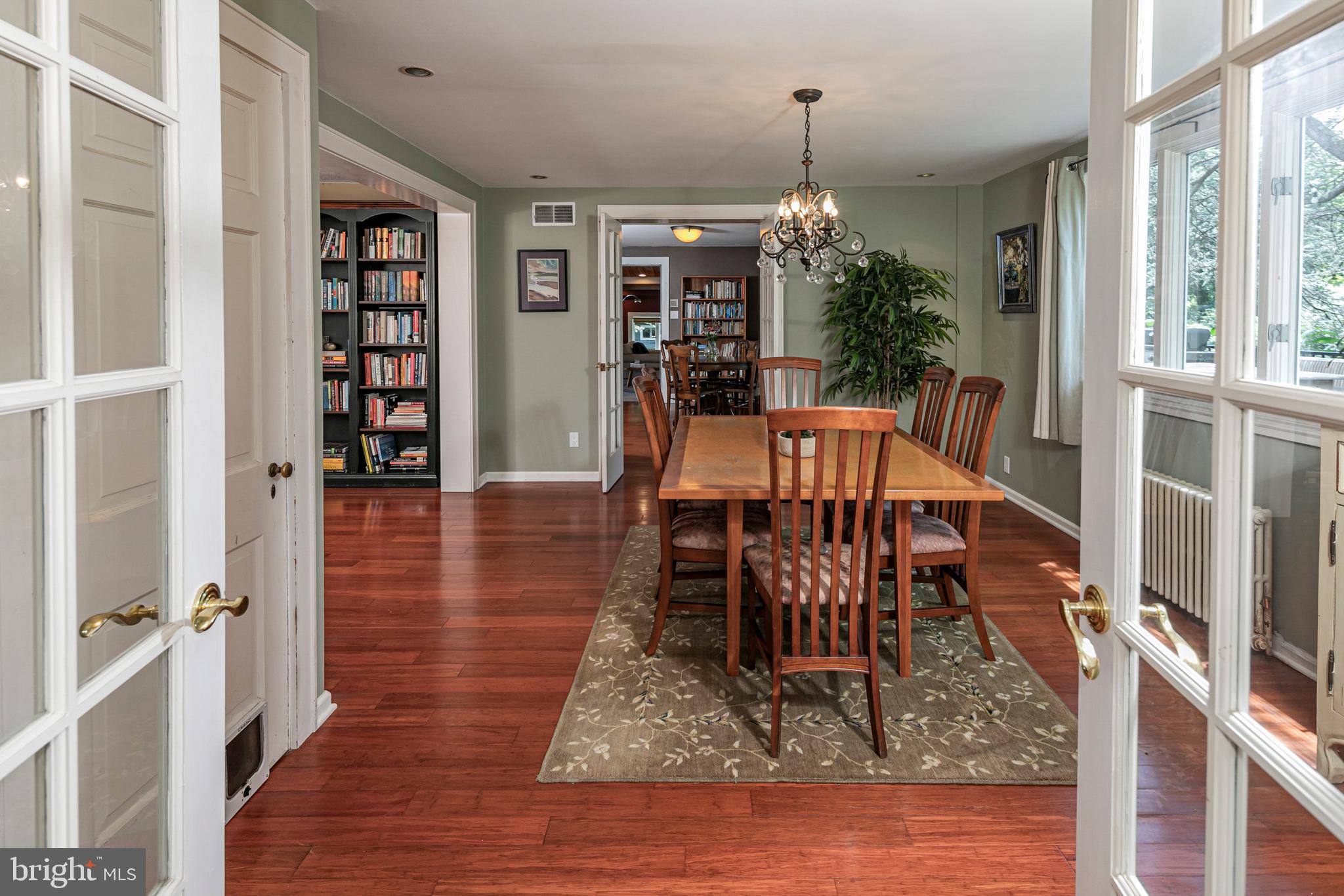 18 Mercer Street Hopewell, NJ 08525 - Photo 16 of 64 a dining room with wooden floor a chandelier a glass table and chairs