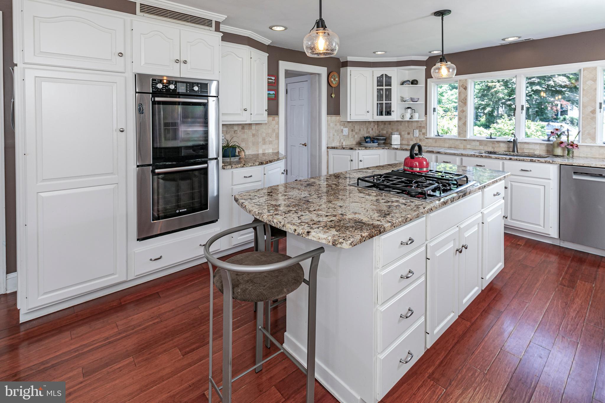18 Mercer Street Hopewell, NJ 08525 - Photo 27 of 64 a kitchen with stainless steel appliances kitchen island granite countertop a sink stove and refrigerator