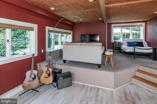 a view of a bedroom with furniture and windows
