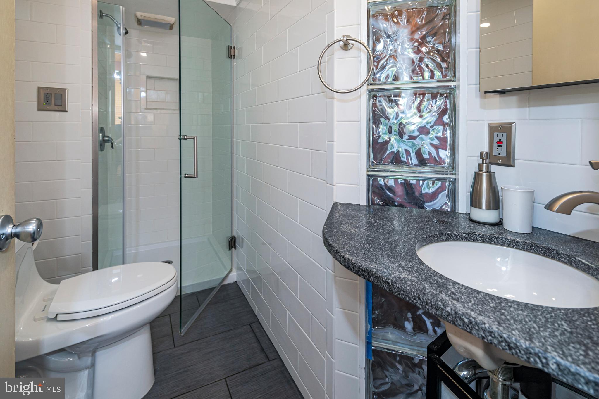 18 Mercer Street Hopewell, NJ 08525 - Photo 35 of 64 a bathroom with a granite countertop toilet sink and mirror