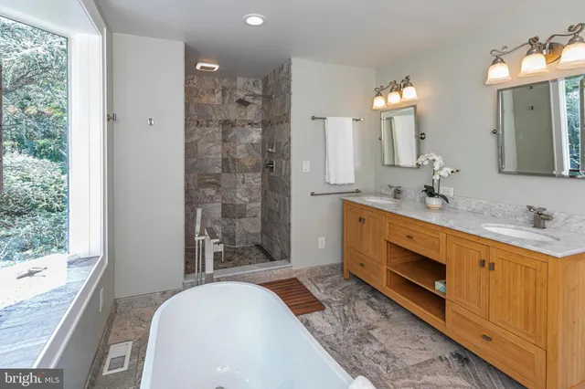 a bathroom with a granite countertop shower a mirror and a sink