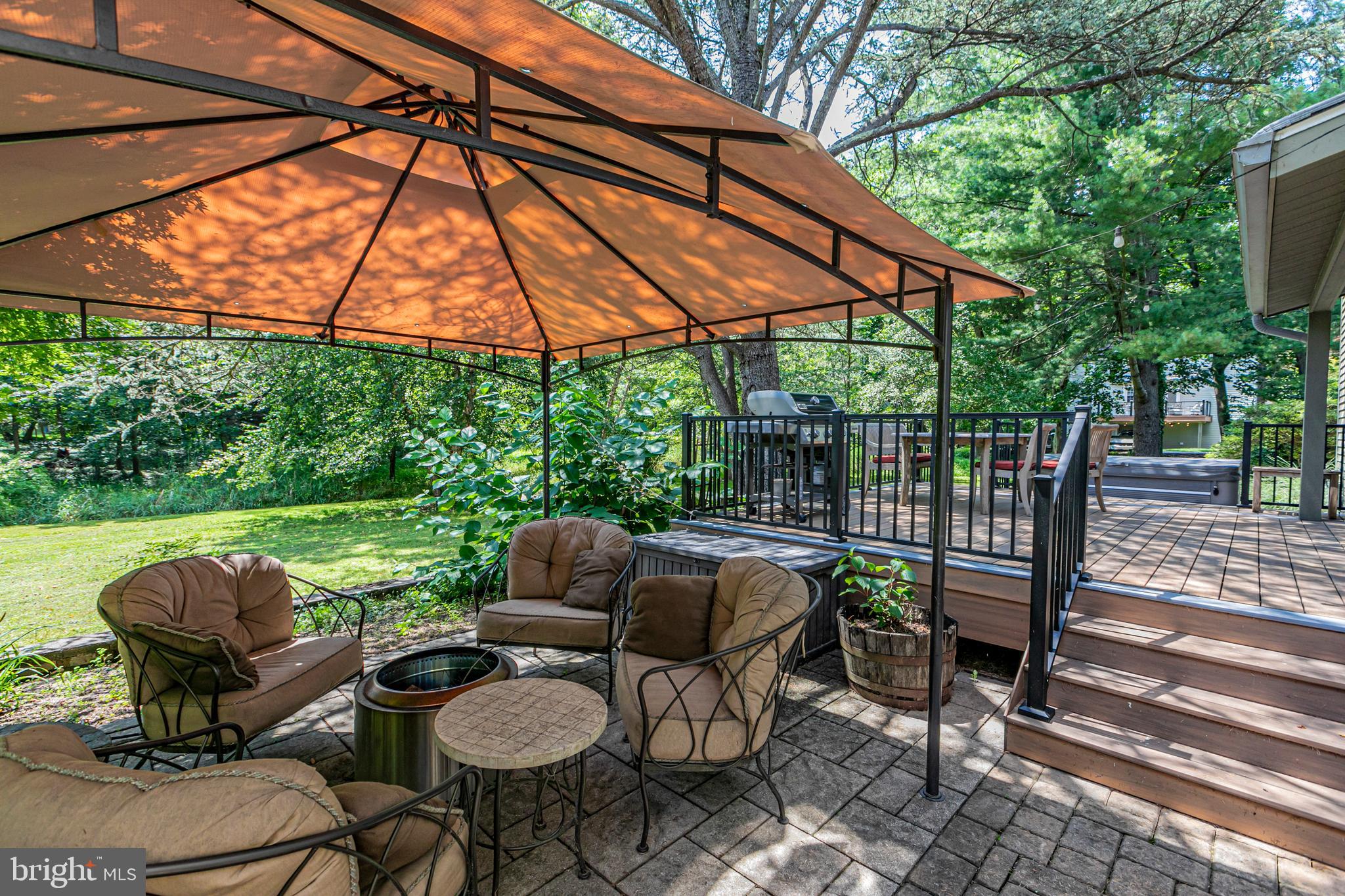 18 Mercer Street Hopewell, NJ 08525 - Photo 59 of 64 a patio with wooden floor a yard a table and chairs