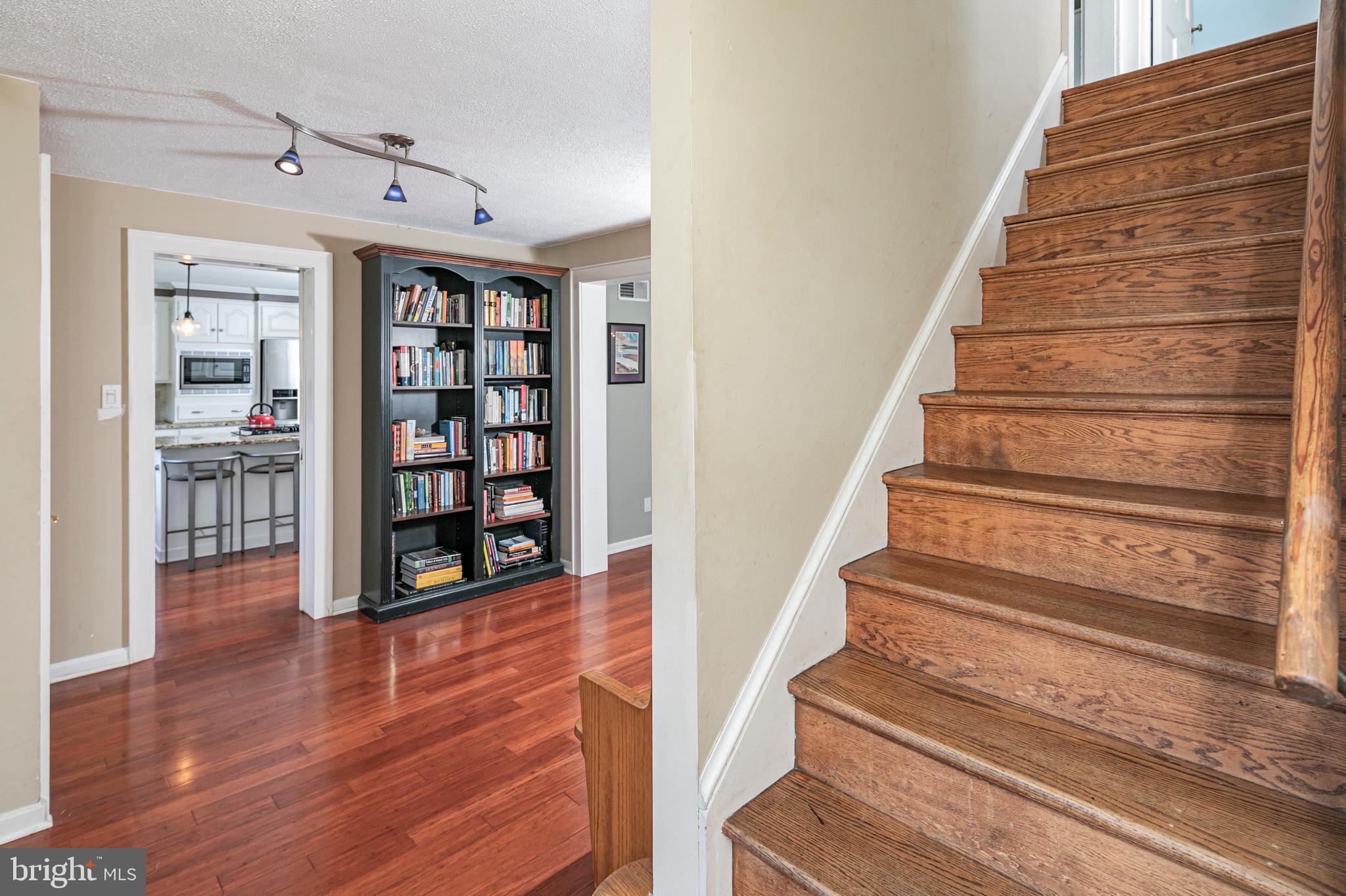18 Mercer Street Hopewell, NJ 08525 - Photo 6 of 64 a view of staircase with wooden floor and a book shelf