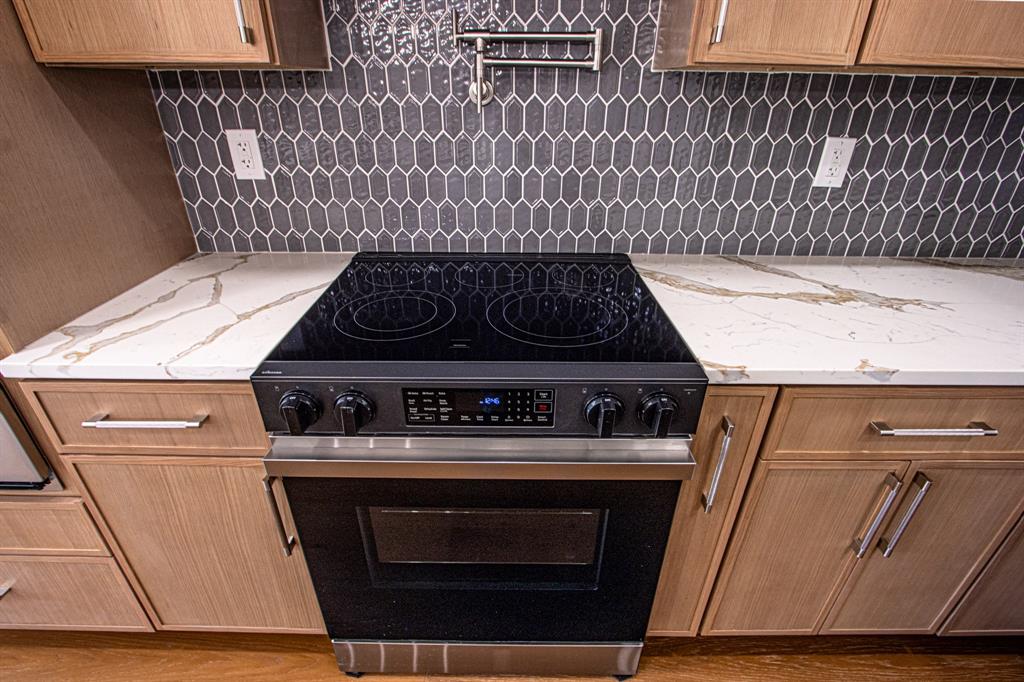 108 Winding Way Azle, TX 76020 - Photo 11 of 39 Kitchen featuring electric stove, light stone counters, and wood finished floors