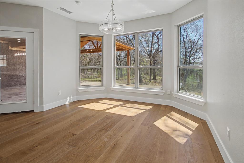 108 Winding Way Azle, TX 76020 - Photo 15 of 39 Unfurnished dining area featuring light wood-style flooring and hanging lights