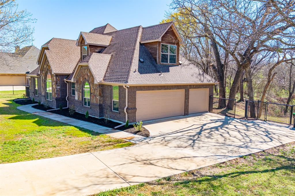108 Winding Way Azle, TX 76020 - Photo 2 of 39 View of front of property with concrete driveway, stone siding, roof with shingles, brick siding, and a garage