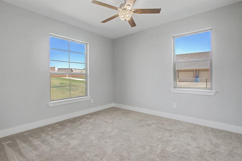 108 Winding Way Azle, TX 76020 - Photo 21 of 39 Carpeted empty room with plenty of natural light and ceiling fan