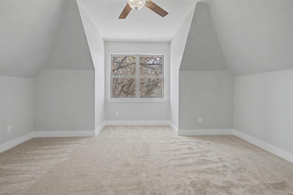 108 Winding Way Azle, TX 76020 - Photo 24 of 39 Additional living space with light colored carpet, vaulted ceiling, and a ceiling fan
