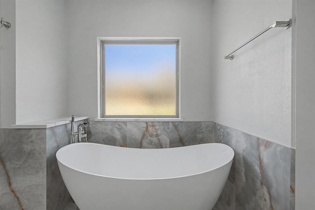 108 Winding Way Azle, TX 76020 - Photo 26 of 39 Full bath featuring a soaking tub, wainscoting, and tile walls