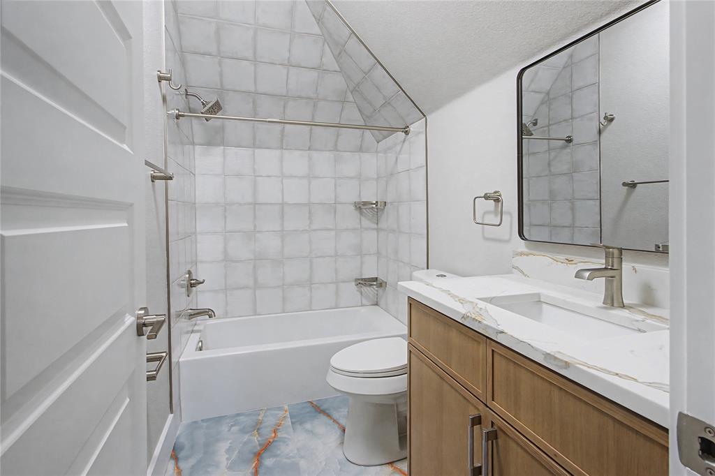 108 Winding Way Azle, TX 76020 - Photo 29 of 39 Bathroom featuring vanity and washtub / shower combination