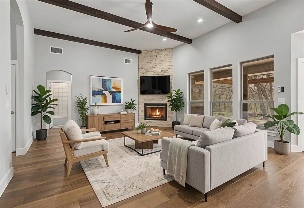 108 Winding Way Azle, TX 76020 - Photo 3 of 39 Living room featuring a stone fireplace, a ceiling fan, and wood finished floors