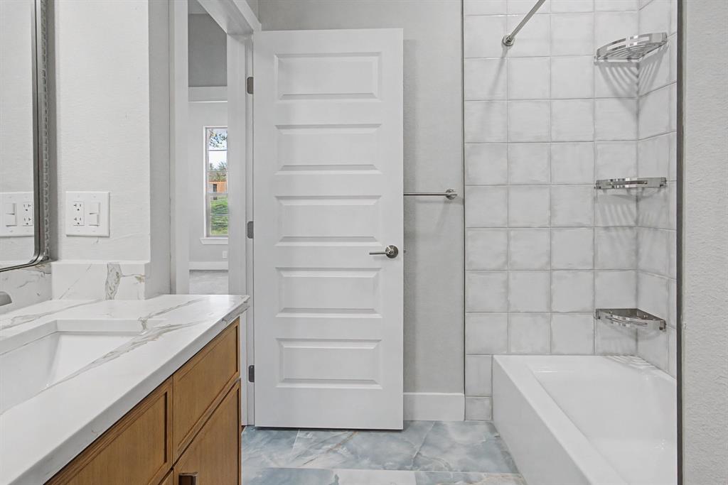 108 Winding Way Azle, TX 76020 - Photo 31 of 39 Bathroom featuring vanity and bathtub / shower combination