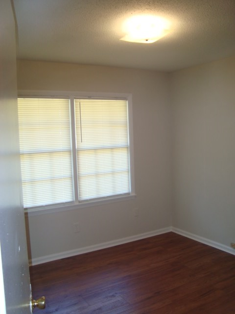 8224 Bryn Mawr Lane Columbus, GA 31904 - Photo 12 of 19 an empty room with wooden floor and windows