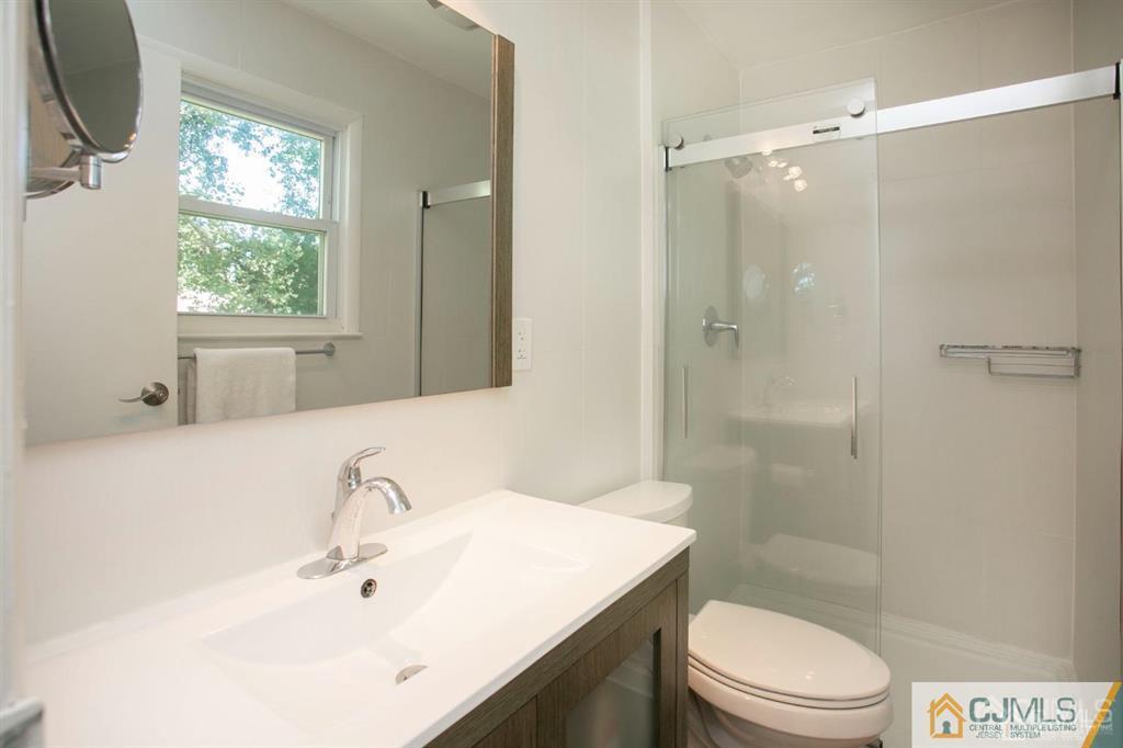 7 Douglas Drive Edison, NJ 08817 - Photo 18 of 26 a bathroom with a sink toilet a mirror and shower