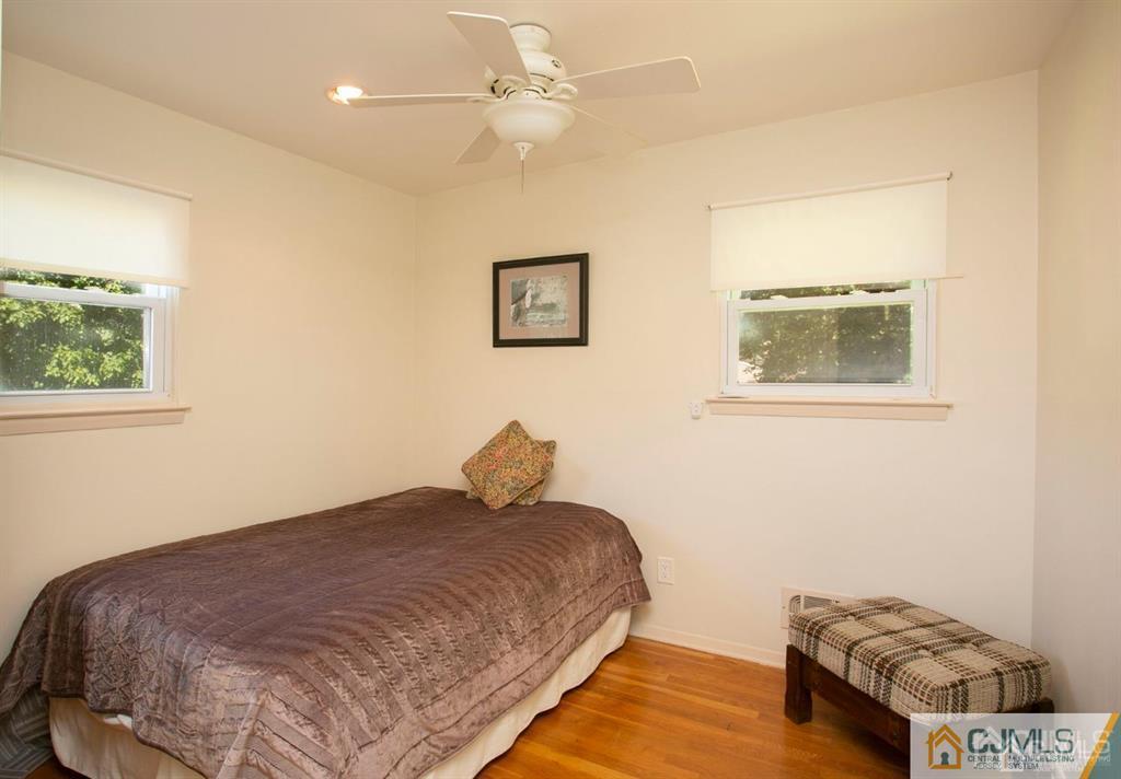 7 Douglas Drive Edison, NJ 08817 - Photo 19 of 26 a bedroom with a bed and a painting on the wall