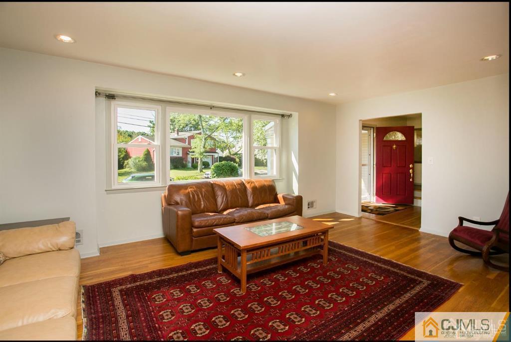 7 Douglas Drive Edison, NJ 08817 - Photo 4 of 26 a living room with furniture and a rug