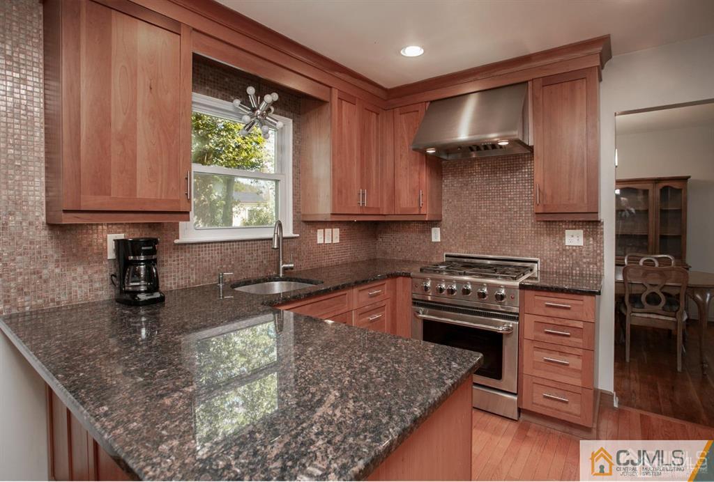 7 Douglas Drive Edison, NJ 08817 - Photo 8 of 26 a kitchen with stainless steel appliances granite countertop a sink stove and refrigerator