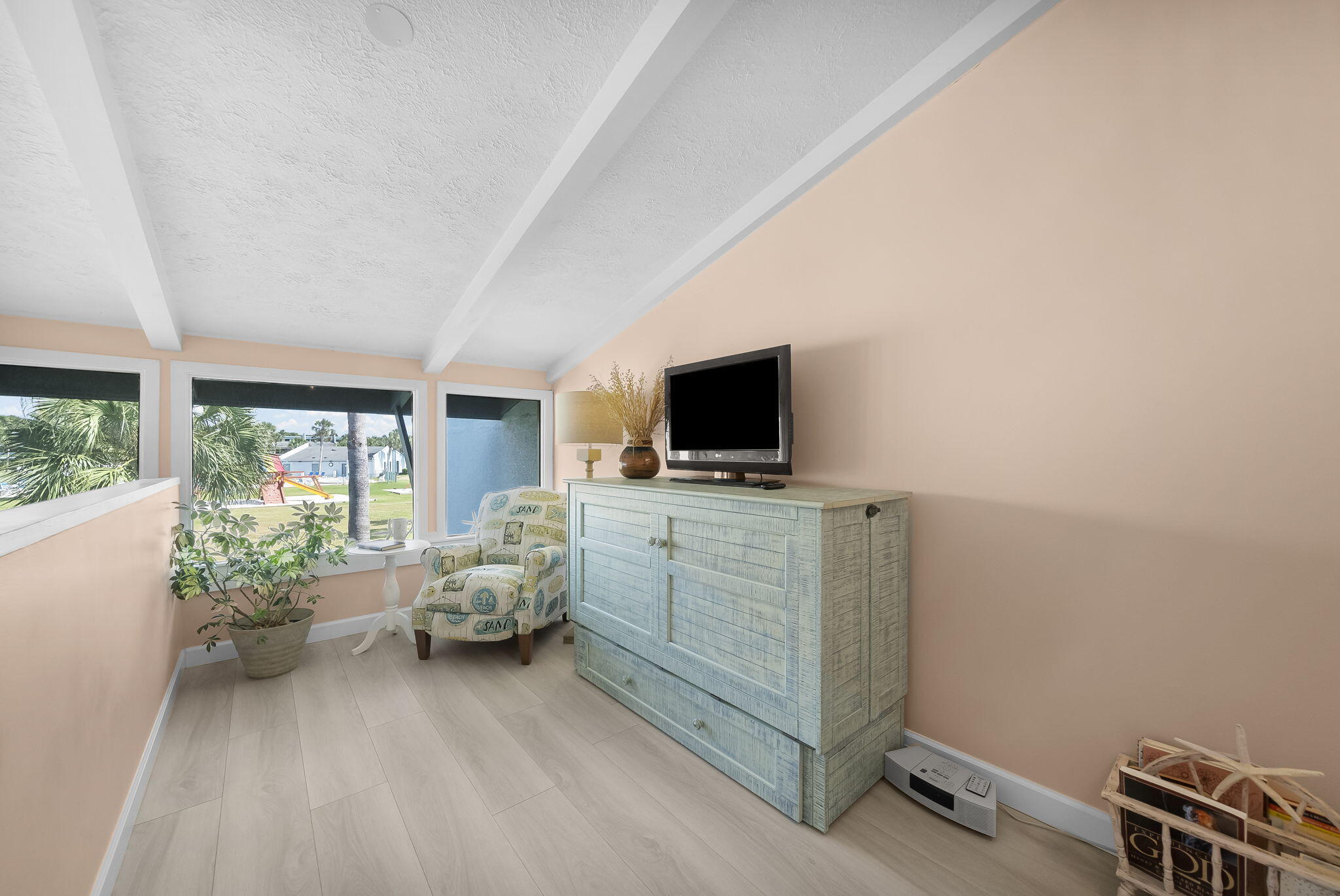 22400 Front Beach Road, Unit 24 Panama City Beach, FL 32413 - Photo 18 of 41 a room with furniture and flat screen tv