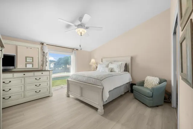 a bedroom with a bed and a television