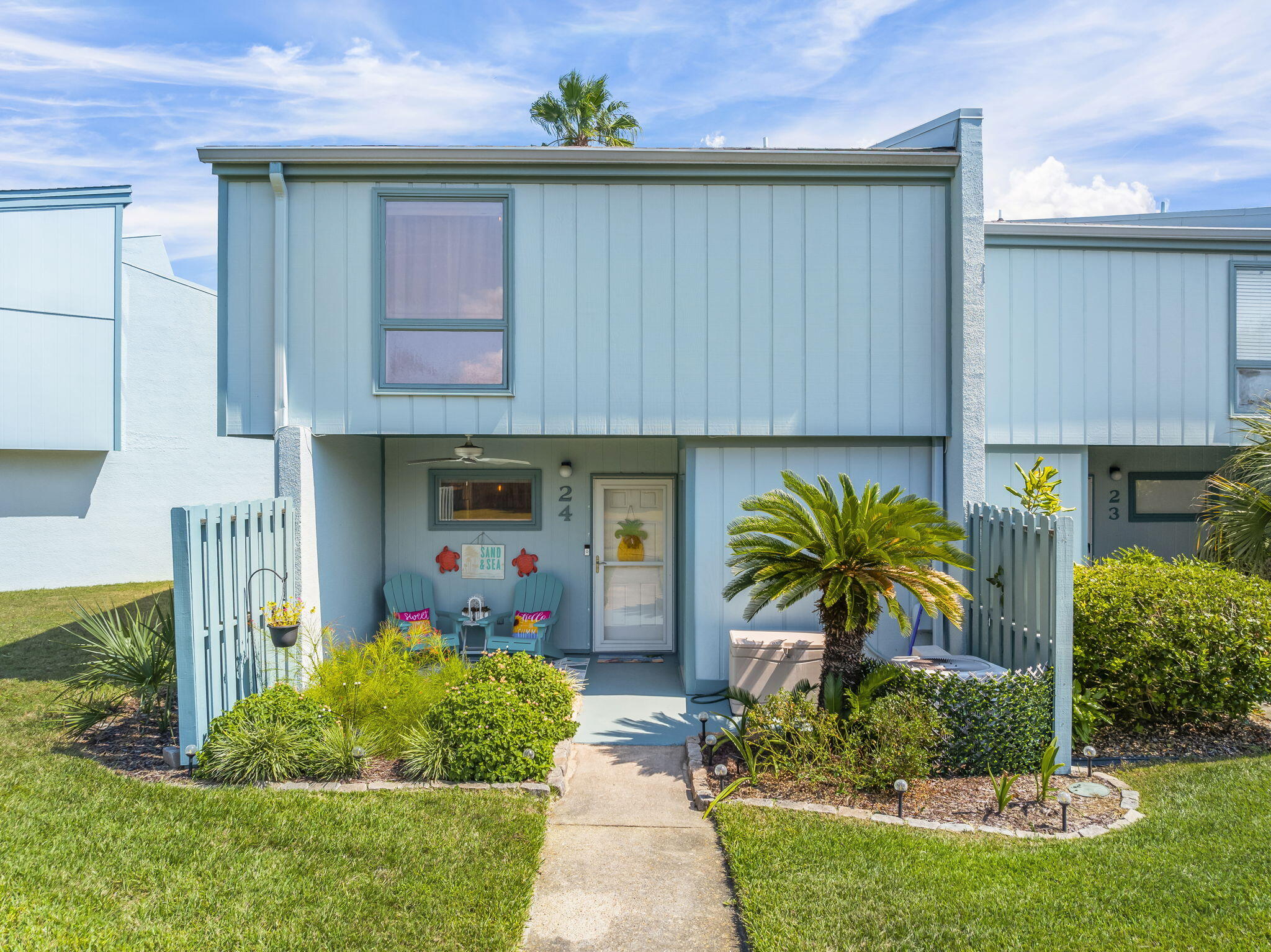 22400 Front Beach Road, Unit 24 Panama City Beach, FL 32413 - Photo 2 of 41 a front view of a house with garden