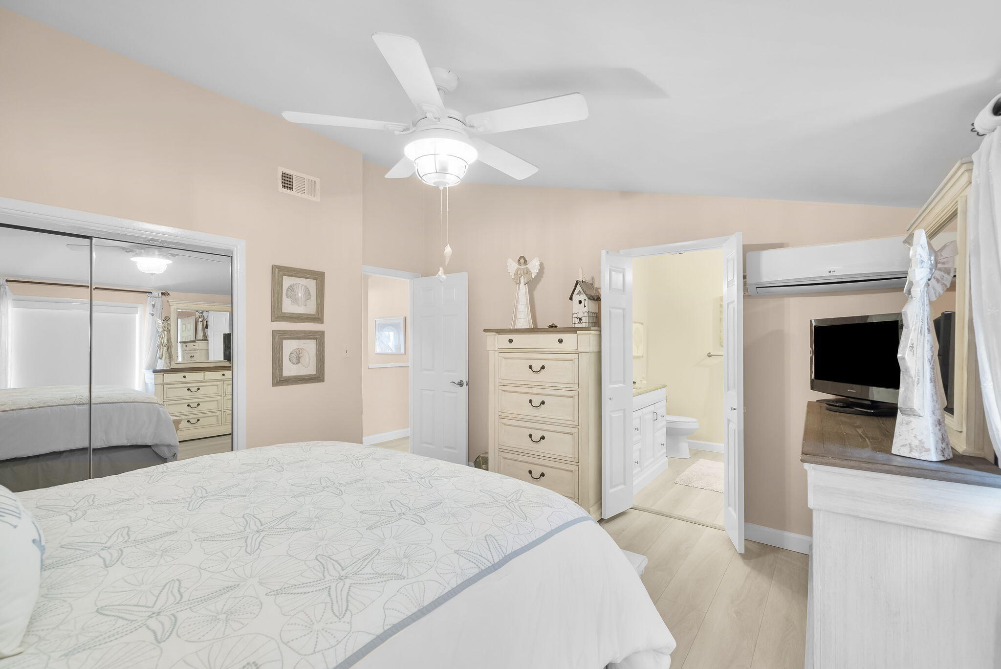 22400 Front Beach Road, Unit 24 Panama City Beach, FL 32413 - Photo 22 of 41 a bedroom with a large bed and a chandelier