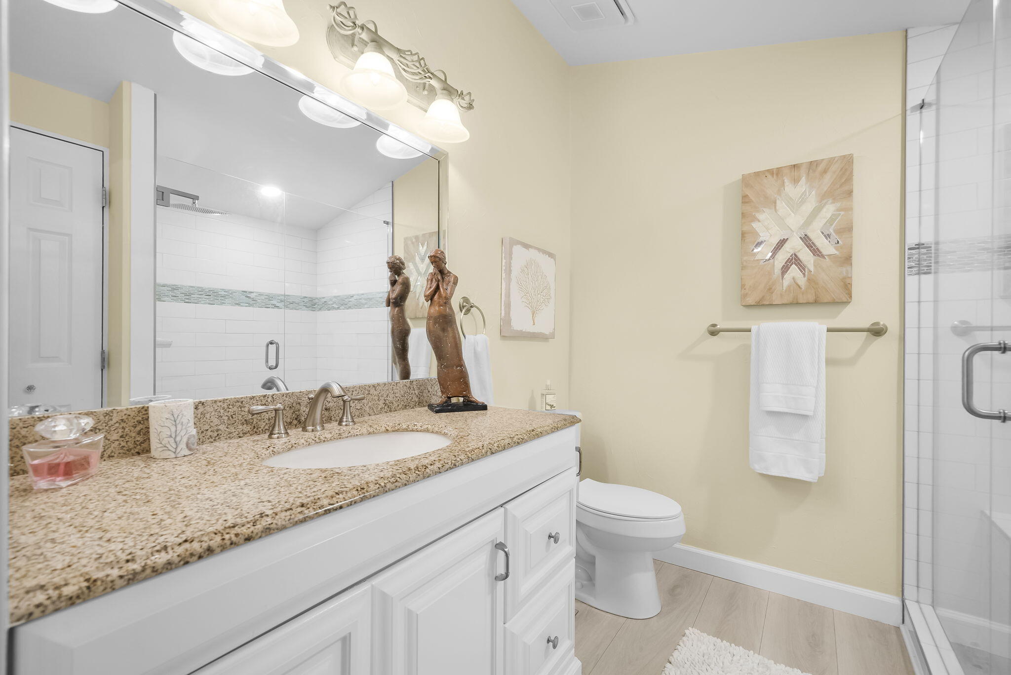 22400 Front Beach Road, Unit 24 Panama City Beach, FL 32413 - Photo 23 of 41 a bathroom with a granite countertop sink a toilet and a mirror