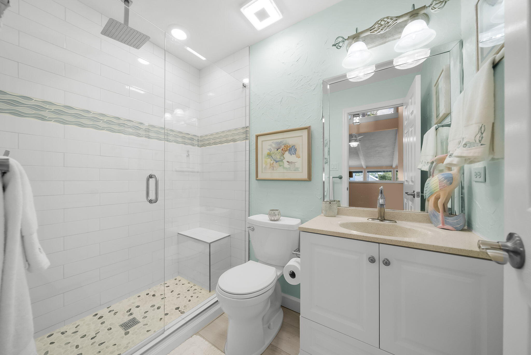 22400 Front Beach Road, Unit 24 Panama City Beach, FL 32413 - Photo 26 of 41 a bathroom with a sink a toilet a mirror and shower