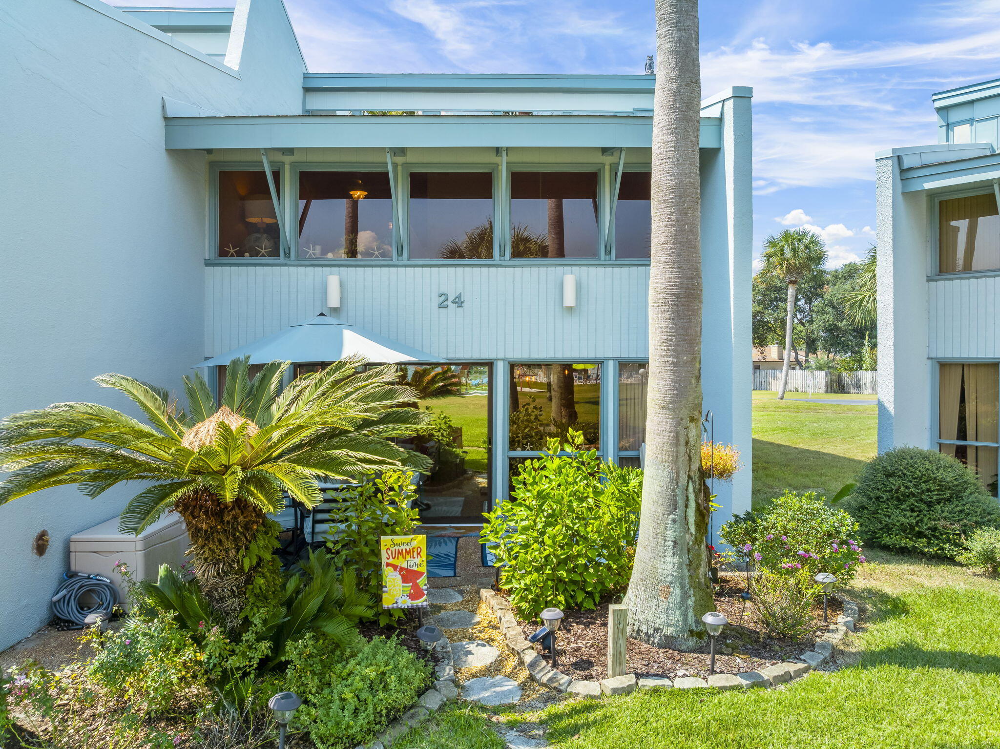 22400 Front Beach Road, Unit 24 Panama City Beach, FL 32413 - Photo 30 of 41 a front view of a house with garden