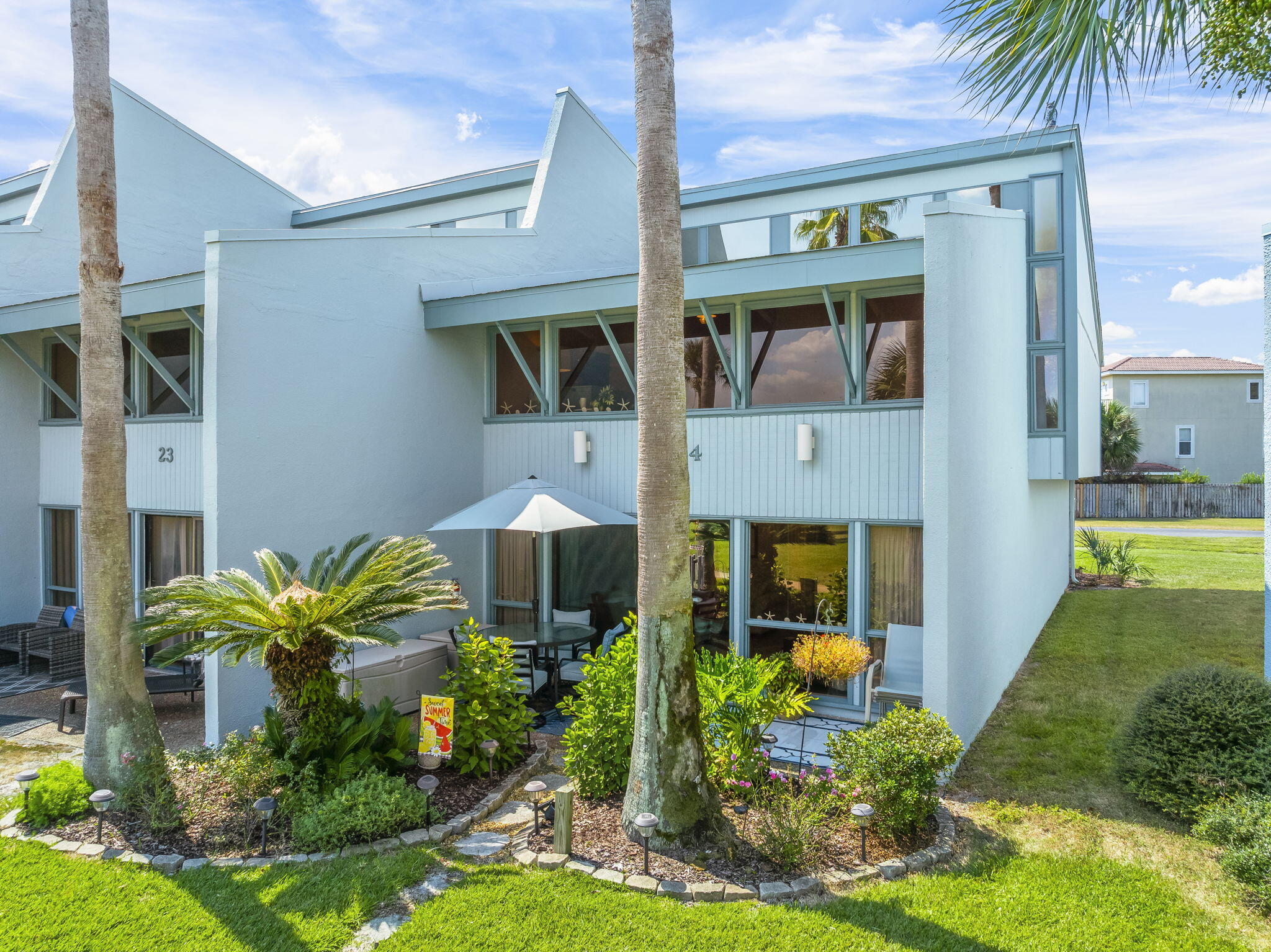 22400 Front Beach Road, Unit 24 Panama City Beach, FL 32413 - Photo 3 of 41 a front view of a house with garden