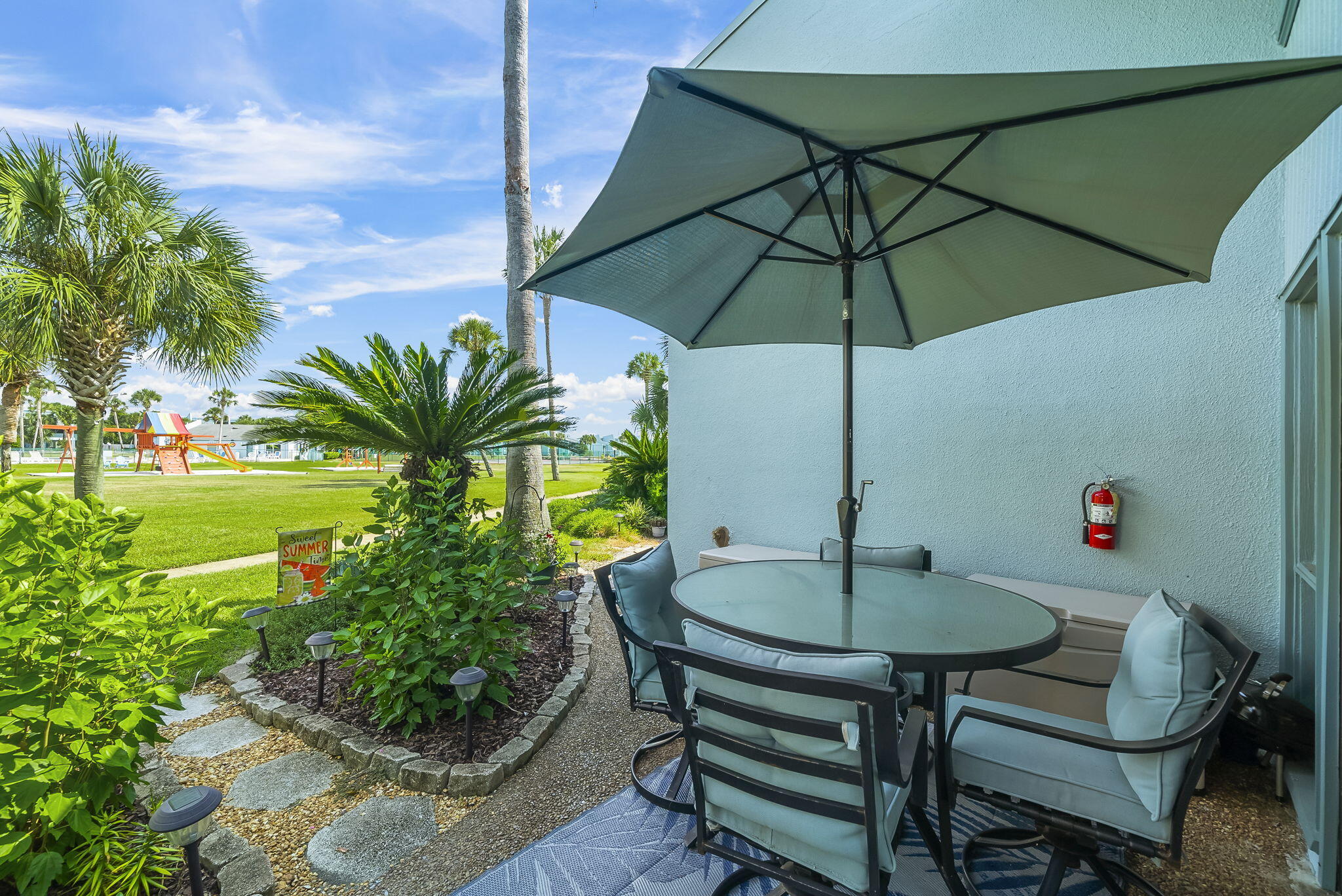 22400 Front Beach Road, Unit 24 Panama City Beach, FL 32413 - Photo 33 of 41 a table and chairs in the patio