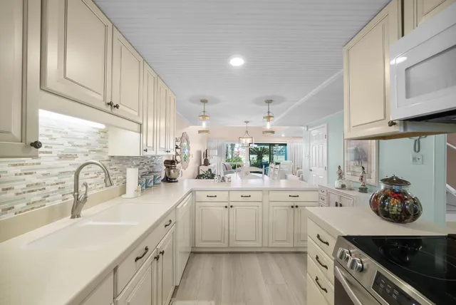 a kitchen with cabinets a sink and appliances