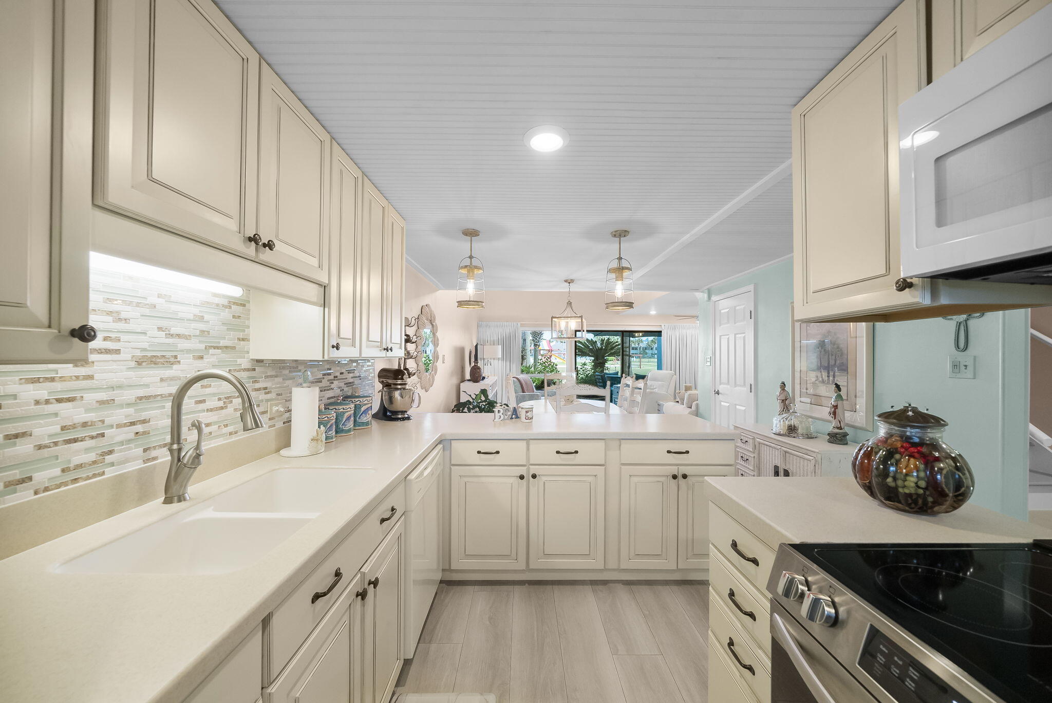 22400 Front Beach Road, Unit 24 Panama City Beach, FL 32413 - Photo 5 of 41 a kitchen with cabinets a sink and appliances