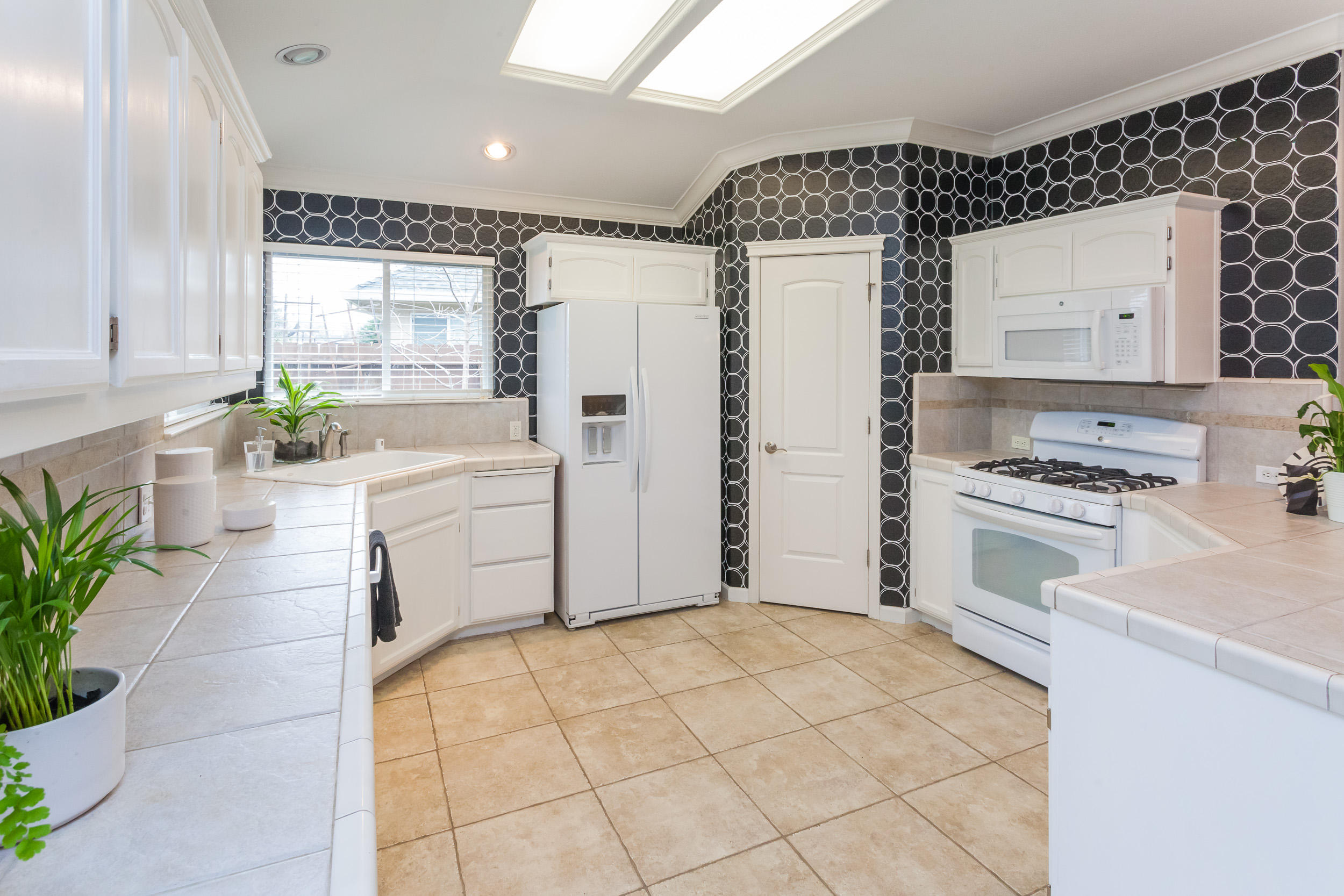 2638 Rhinestone Way Redding, CA 96001 - Photo 8 of 30 a kitchen with stainless steel appliances a refrigerator sink and stove