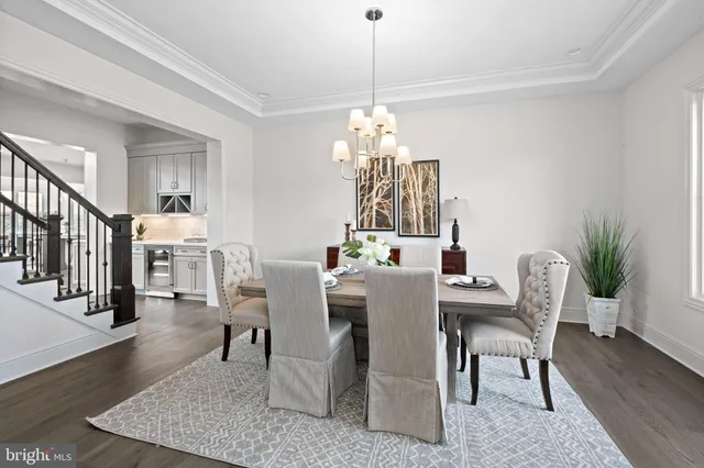 a view of a dining room with furniture wooden floor and chandelier