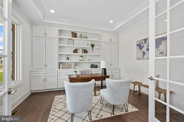 a dining room with wooden floor and windows