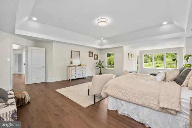 a spacious bedroom with a large bed and a window