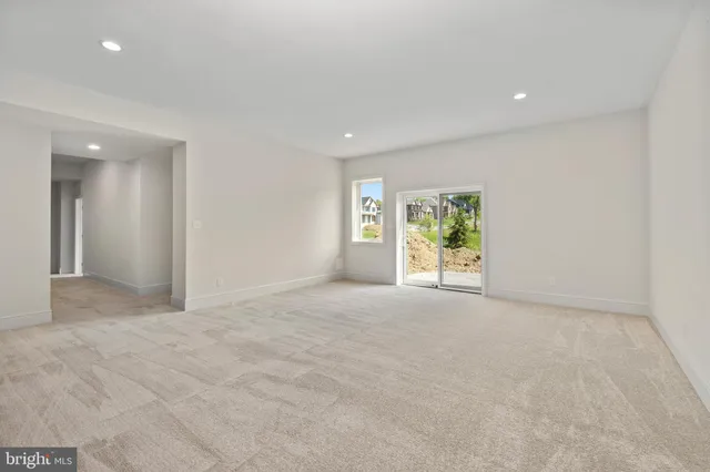 a view of a livingroom with an empty space and a window