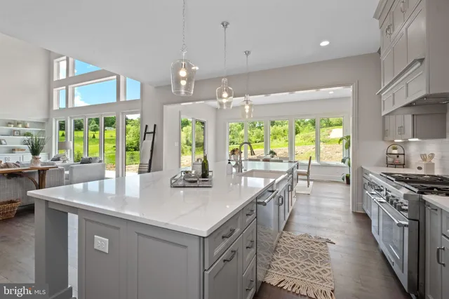 a large kitchen with kitchen island a large island in it