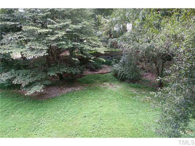 7124 Mill Ridge Road Raleigh, NC 27613 - Photo 21 of 23 A babbling brook borders the rear of the lot