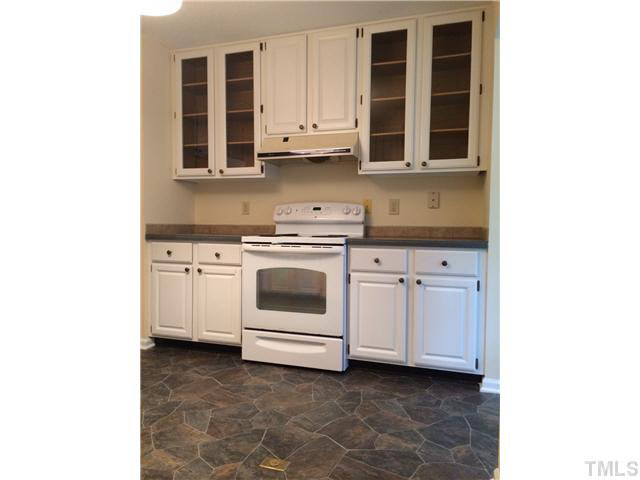 7124 Mill Ridge Road Raleigh, NC 27613 - Photo 8 of 23 A kitchen with a great layout, appliances in good condition, and glass panel cabinets.