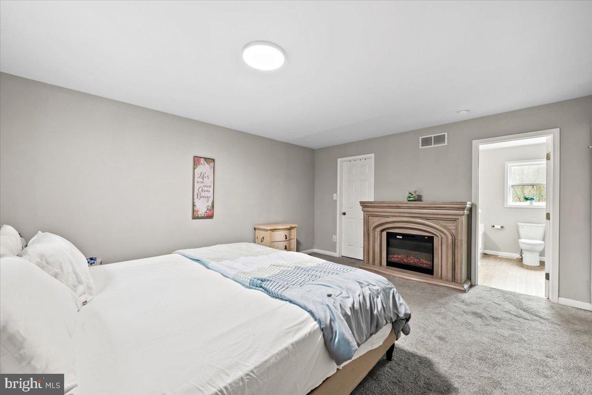 219 Mountain View Jim Thorpe, PA 18229 - Photo 16 of 38 a spacious bedroom with a bed and a fireplace