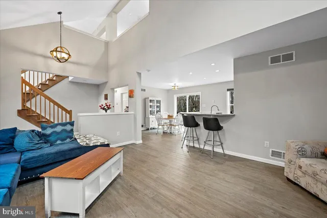 a dining room with furniture a window and wooden floor