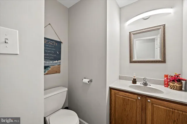 a bathroom with a sink a toilet and mirror