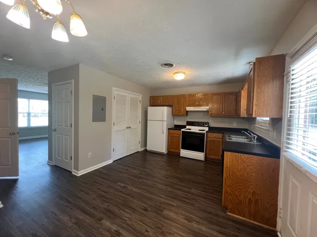 a kitchen with stainless steel appliances granite countertop a stove and a refrigerator