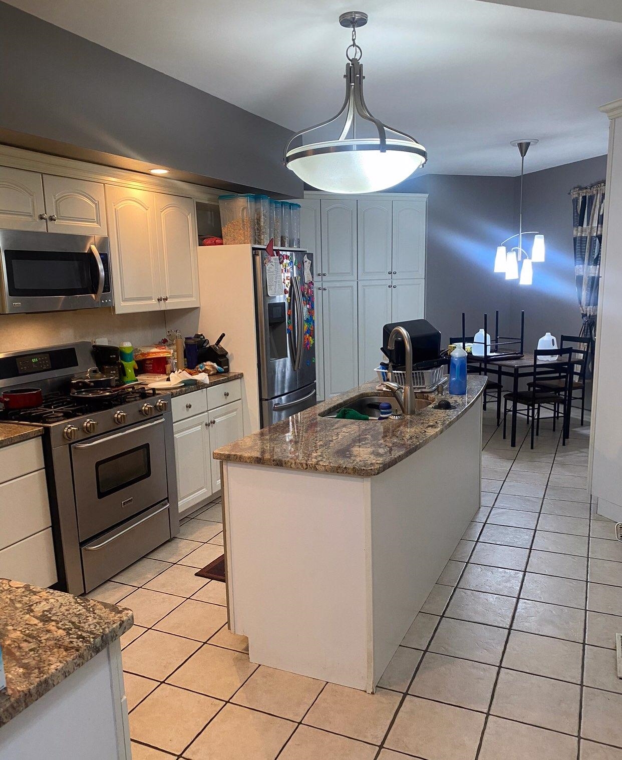 916 Olson Spring Close Belvidere, IL 61008 - Photo 28 of 32 a kitchen with stainless steel appliances granite countertop a stove a sink a microwave and a refrigerator