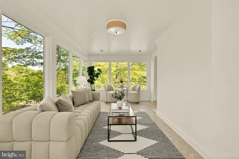 a dining room with furniture and a potted plant