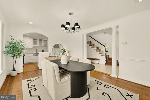 a large kitchen with stainless steel appliances a sink and a refrigerator