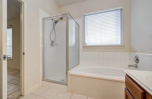 a bathroom with a shower and a sink