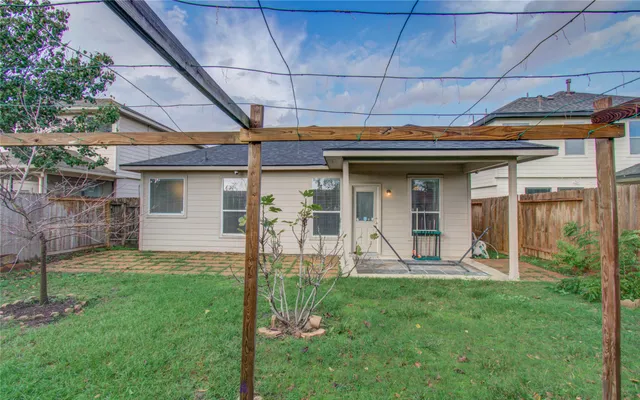 a view of a backyard with table and chairs and potted plants