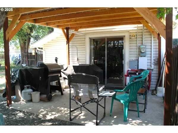 a backyard of a house with table and chairs